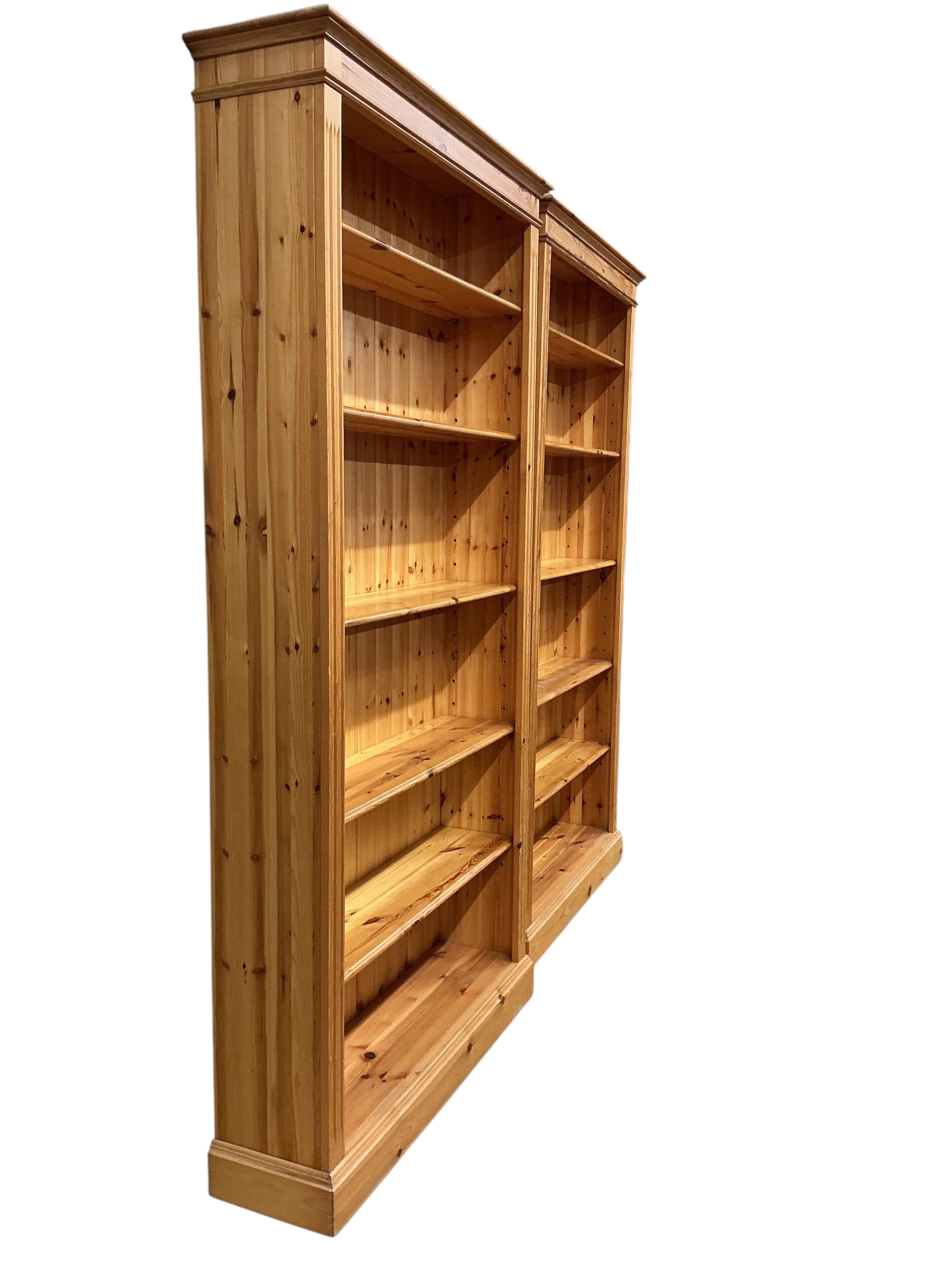 A pair of modern pine open bookcases, width 109cm, depth 29cm, height 212cm